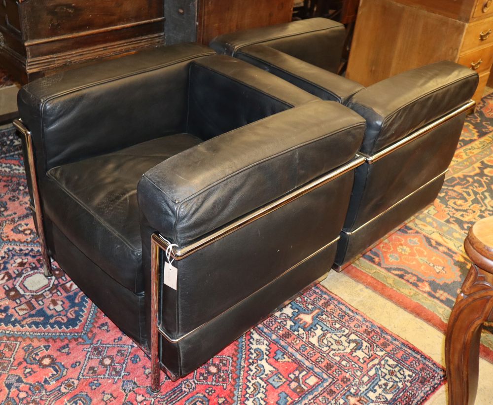 A pair of Le Corbusier style chrome and black leather armchairs, W.74cm, D.70cm, H.67cm
